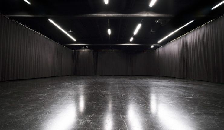 Studio 1: Large film studio rental space with black stage curtains from The Light House.