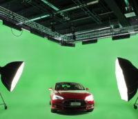 Professional film studio set with a green screen, lighting and a red car from The Light House.