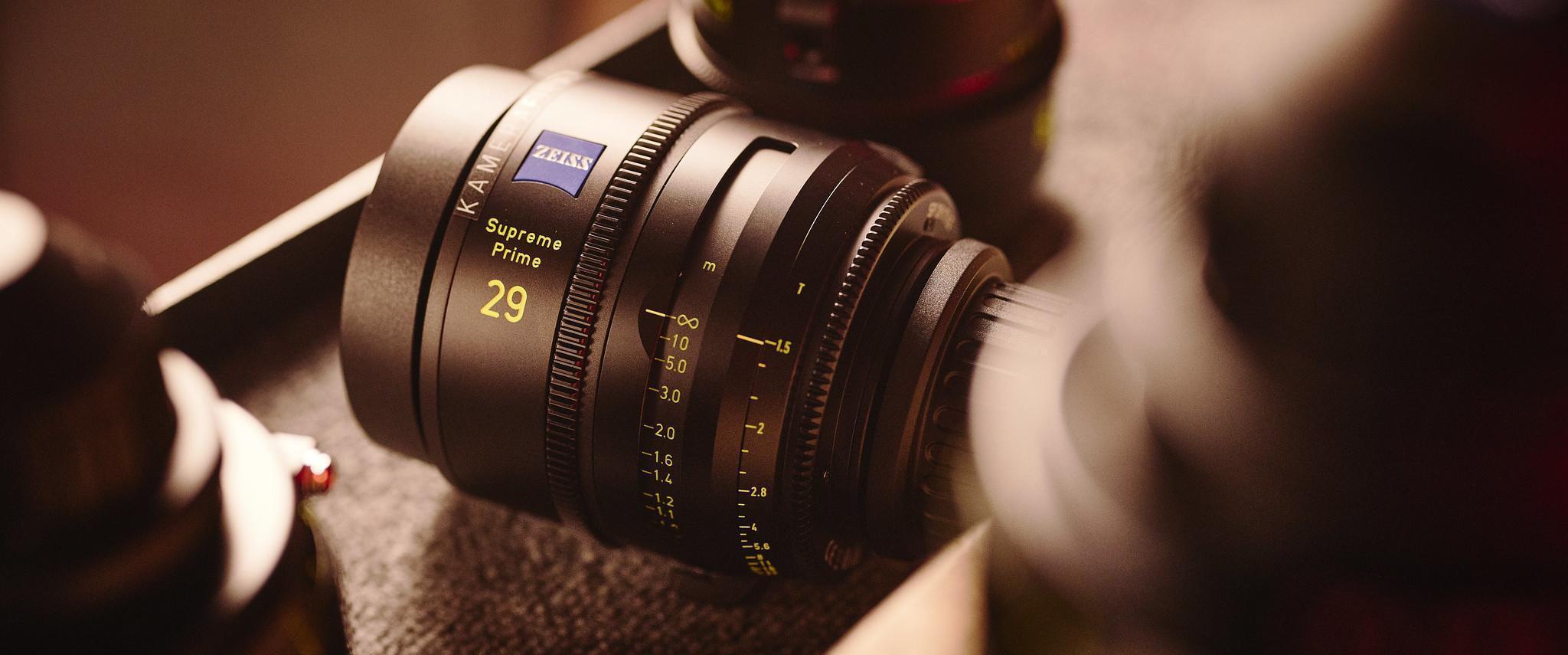 A Zeiss Supreme Prime 29mm camera lens surrounded by other camera lenses.